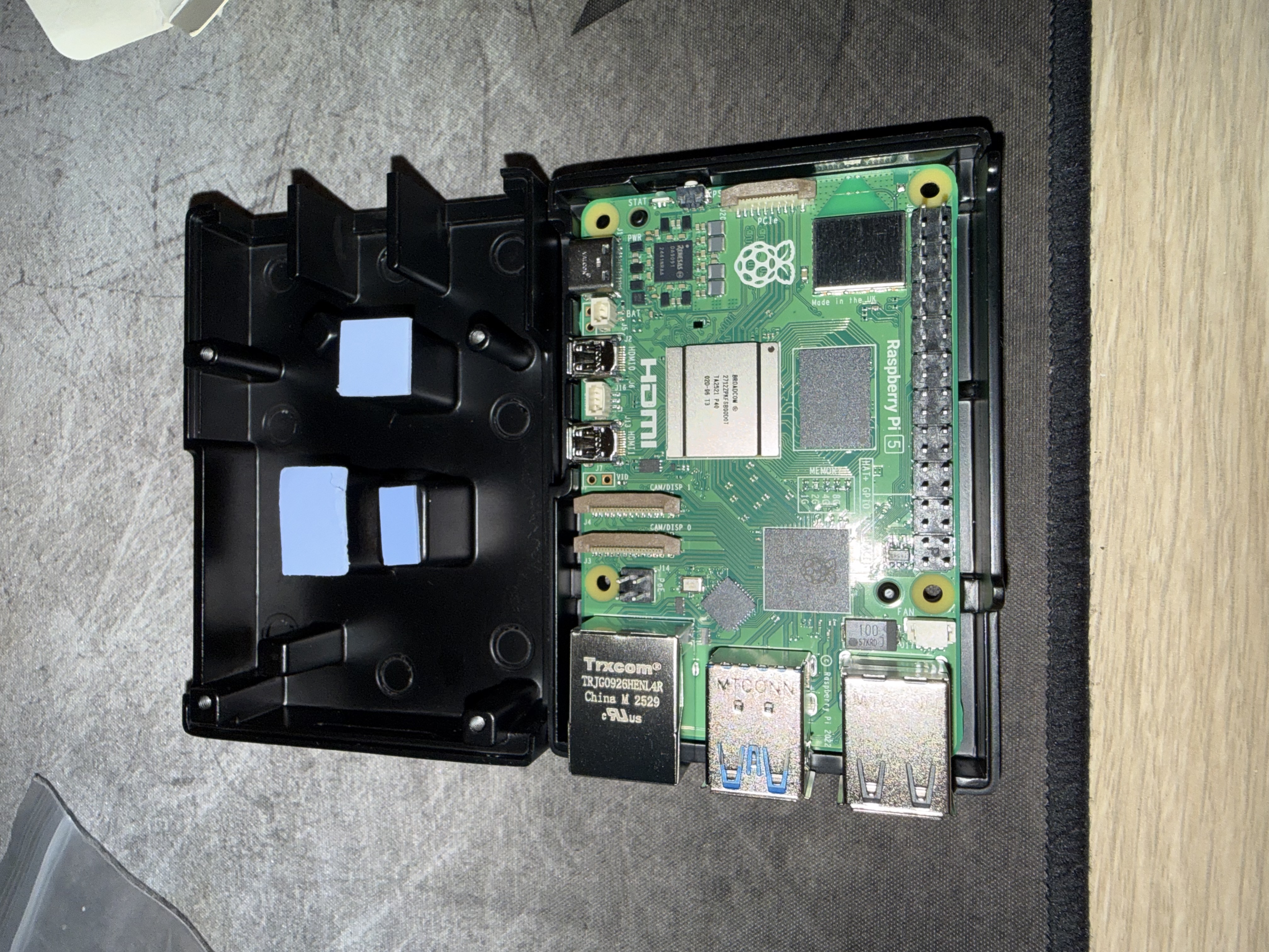 Pi 5 seated in the base tray, ready to close